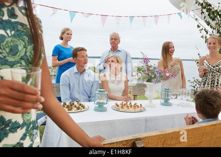 Mid adult couple at wedding reception with group of friends Stock Photo