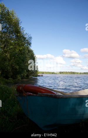 Rowing boat at lakeside in late spring in Finland Stock Photo