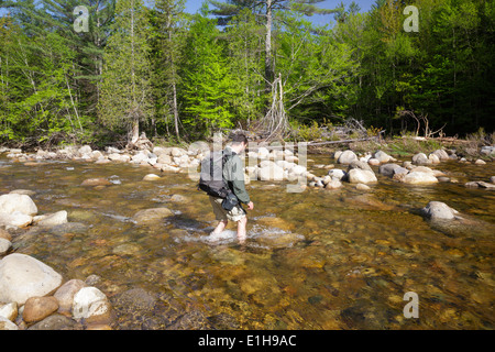 Hiker crossing the East Branch of the Pemigewasset River in the ...