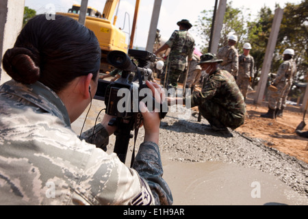 U.S. Air Force Staff Sgt. Amy Slye, left, a broadcast journalist with the 18th Wing, videorecords Royal Thai Armed Forces and I Stock Photo