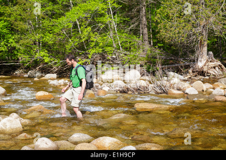 Hiker crossing the East Branch of the Pemigewasset River in the ...