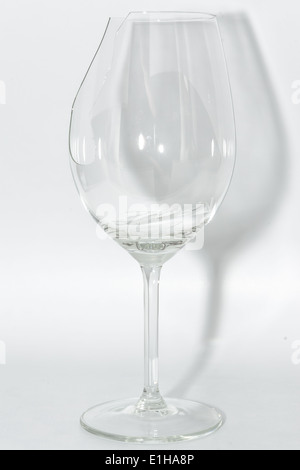 Broken clear wineglass with sharp glass fragments inside on white background Stock Photo