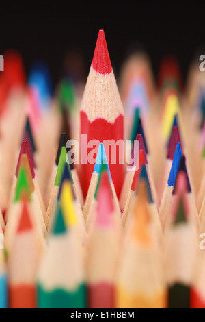 One red crayon standing out from the crowd. Stock Photo