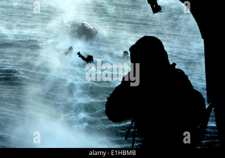 A U.S. Airman with an Air Force Special Operations Weather Team gives a thumbs-up to a crew member aboard an Army CH-47 Chinook Stock Photo