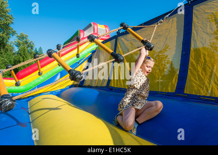 Girl enjoys twirly ladder attraction at Spring Fair, Burnaby, British Columbia, Canada Stock Photo