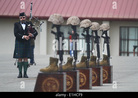 Larry Veach, a former U.S. Marine and a bagpiper of 35 years, plays 'Amazing Grace' during the 2nd Battalion, 4th Marine Regime Stock Photo
