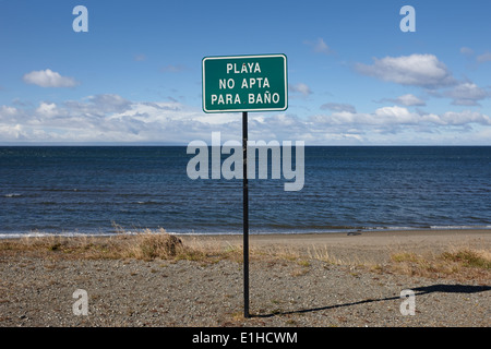 playa no apta para bano unsuitable for swimming strait of magellan coastal shoreline in Punta Arenas Chile Stock Photo