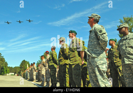 Soldiers, airmen and marines from eight countries participating in exercise Saber Strike 2012 stand in formation as three U.S. Stock Photo