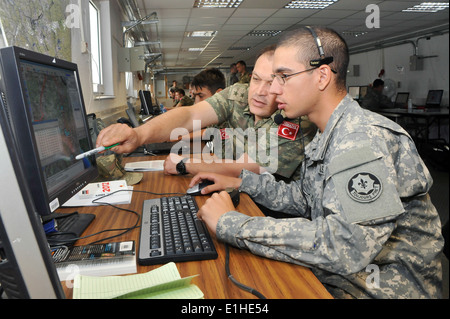 A U.S. Army soldier assigned to 4th Squadron, 2nd Cavalry Regiment (right) and a Turkish Land Force soldier participate in Coop Stock Photo