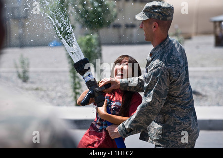 U.S. Air Force Maj. Russell Bastian, right, and Osia Eralieva spray water with a fire hose at the Transit Center at Manas, Kyrg Stock Photo