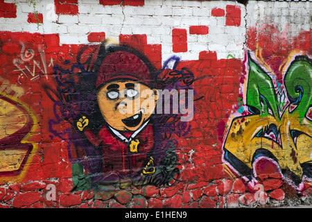 Urban art depicting a young toothless boy in the Spanish colonial city of Santiago de Queretaro, Mexico Stock Photo
