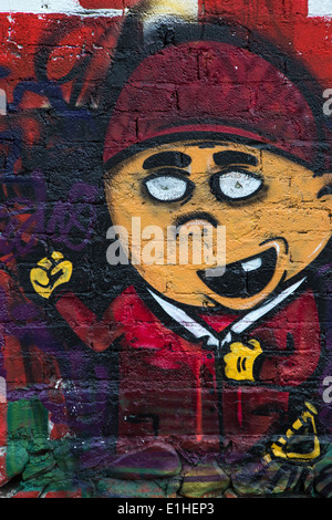 Urban art depicting a young toothless boy in the Spanish colonial city of Santiago de Queretaro, Mexico Stock Photo