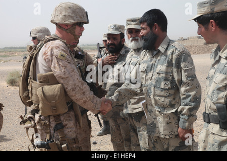 U.S. Marine Corps Maj. Gen. David H. Berger, left, the commanding general of Task Force Leatherneck, is greeted by members of t Stock Photo