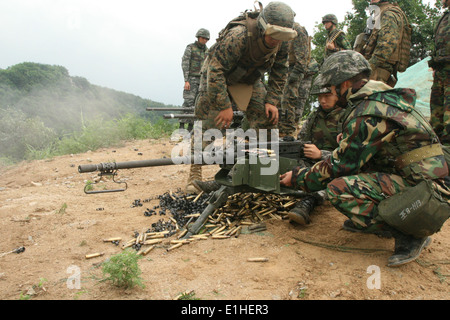 South Korean marine Lance Cpl. Park Seung Yeon, center, fires the M2 .50-caliber machine gun as another South Korean marine and Stock Photo