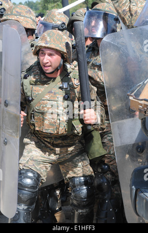 Armenian soldiers press forward to end a mock riot during the Kosovo Force (KFOR) 16 Mission Rehearsal Exercise Aug. 21, 2012, Stock Photo