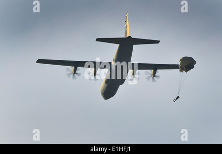 U.S. and Polish service members jump from a U.S. Air Force C-130J Super Hercules aircraft to conduct parachute jumps during Pol Stock Photo