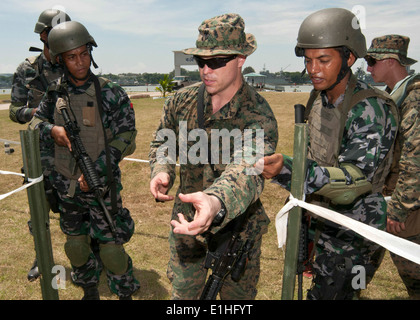 U.S. Marine Corps Cpl. Patrick Thompson, center, assigned to Fleet Antiterrorism Security Team Pacific, trains with Bangladeshi Stock Photo