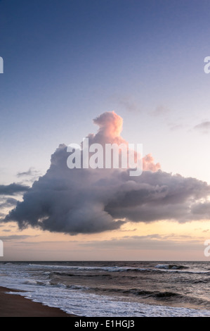 Sunlit cloud hovering over Ponte Vedra Beach (Jacksonville area), Florida at sunrise. Stock Photo