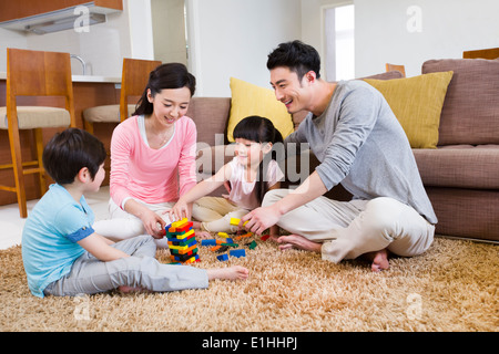 Happy family playing building blocks Stock Photo