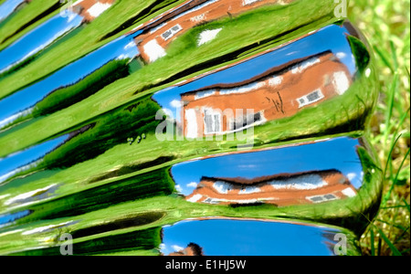 A warped image of a house and garden England uk. Reflection from a garden ornament Stock Photo