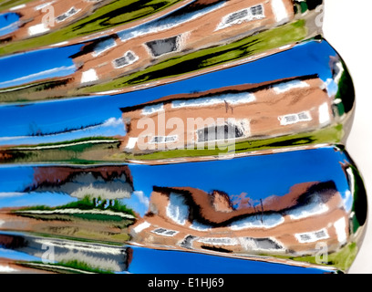 A warped image of a house and garden England uk. Reflection from a garden ornament Stock Photo