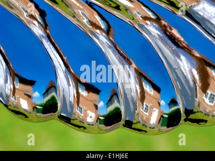 A warped image of a house and garden England uk. Reflection from a garden ornament Stock Photo