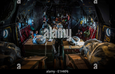 Loadmasters from the 36th Airlift Squadron, Yokota Air Base, Japan, prepare humanitarian aid bundles destined for remote island Stock Photo