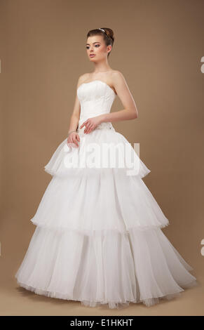 Elegance. Young Lady in Long Classic Bridal Dress Stock Photo