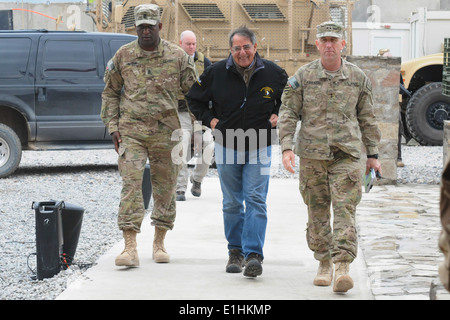U.S. Secretary of Defense Leon Panetta, center, walks with Army Maj. Gen. Robert Abrams, right, the commanding general of the 3 Stock Photo