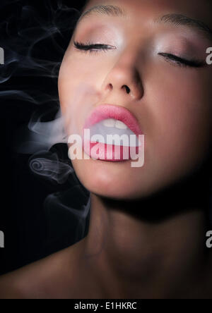Dependence. Addiction. Woman Smoker Exhales Smoke of Cigarette Stock Photo