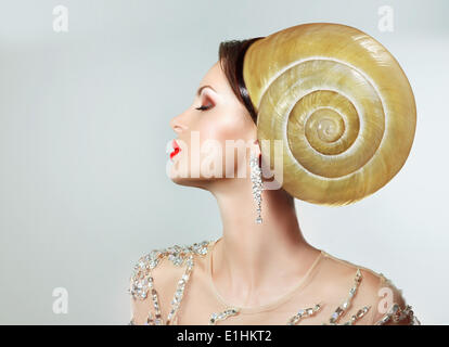 Extravagancy. Outlandish Extreme Hairstyle. Peculiar Woman with Snail as Headwear Stock Photo