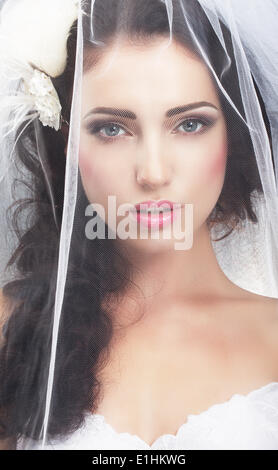 Delicacy. Caucasian Woman Hidden behind Traditional Bridal Veil Stock Photo