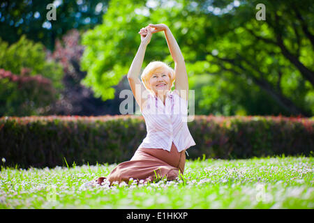 Wellness. Mental Health. Optimistic Old Woman Exercising in Open Air Stock Photo