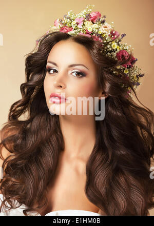 Classy Fashion Model with Perfect Flossy Brown Hair and Wreath of Flowers Stock Photo