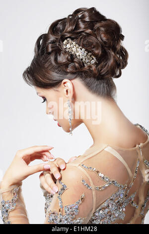 Elegance and Chic. Beautiful Brunette with Classy Hairstyle. Luxury Stock Photo