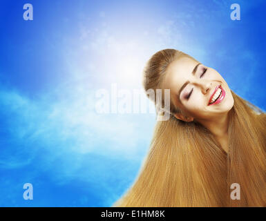 Positive Emotions. Portrait of Laughing Teen Girl over Sunny Blue Sky. Jubilance Stock Photo