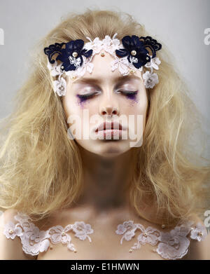 Relax. Styled Enigmatic Blonde with Painted Skin. Dreams with Closed Eyes. Beauty Stock Photo