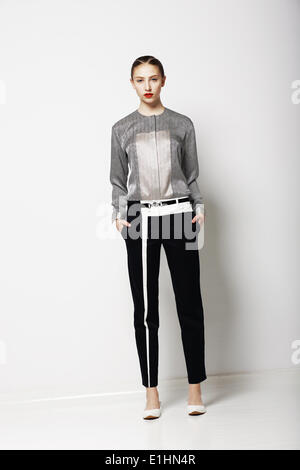 Attitude. Glamor. Fashion Model in Modern Grey Costume. Spring Time Collection. Trend Stock Photo