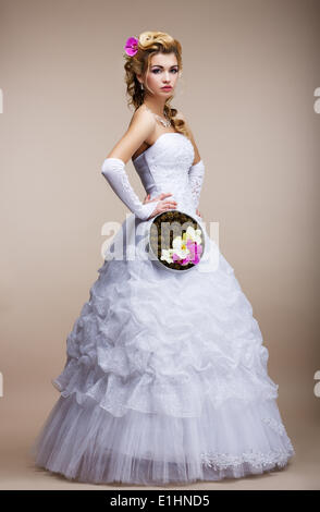 Wedding. Newlywed in White Dress holding Special Bouquet of Flowers Stock Photo