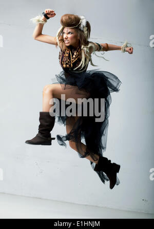 Tribe. Wild tribal person jumping - retro fashion ancient style. Antique Stock Photo