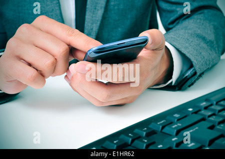 a businessman using a smartphone in the office Stock Photo
