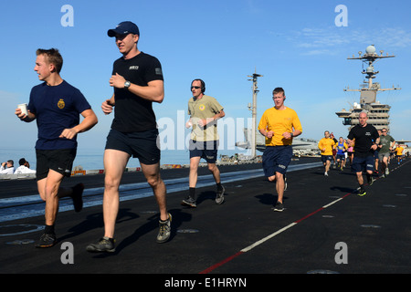 U.S. Sailors participate in a 5-kilometer run on the flight deck of the aircraft carrier USS John C. Stennis (CVN 74) Jan. 18, Stock Photo