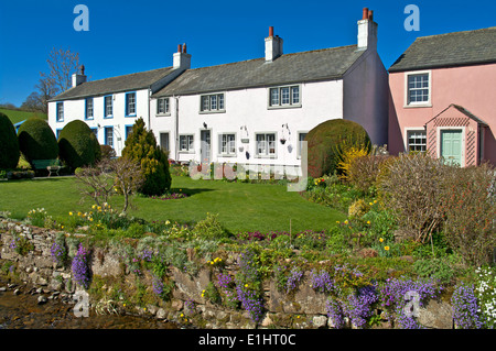 Traditional old painted cottages with pretty gardens in the village of Caldbeck, Cumbria, Lake District National Park England Uk Stock Photo