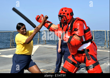 Yeoman 1st Class Charma Smalls, left, practices nonlethal tactics on Information Systems Technician 3rd Class Jasmaine Brooks a Stock Photo