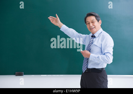 Professor teaching in classroom Stock Photo