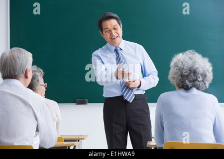 Teacher and students in university for the elderly Stock Photo