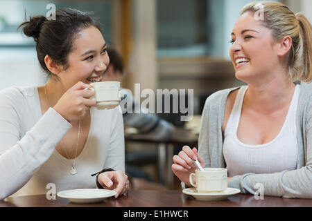 Two laughing students in college coffee shop Stock Photo