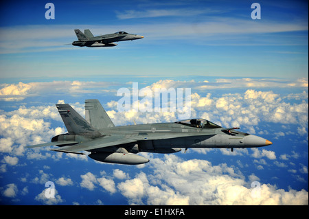 Two Royal Australian Air Force F/A-18 Hornets form up in preparation to conduct in-flight refueling while participating in Cope Stock Photo