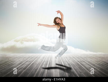 Woman jumping over wooden boards Stock Photo