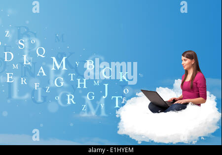 Young woman sitting in cloud with laptop Stock Photo